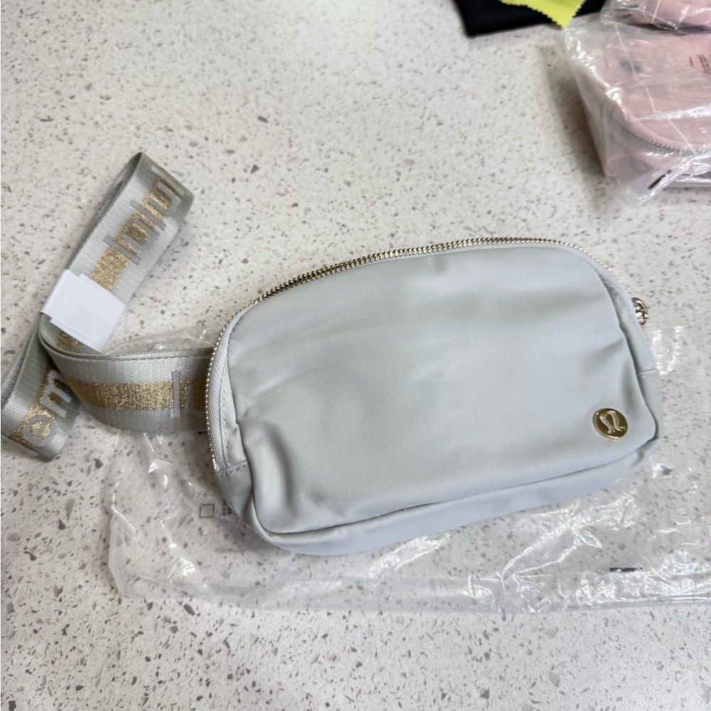 LuluLemon Light Gray Crossbody Bag with Gold Accents